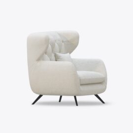 White tufted armchair with black legs.
